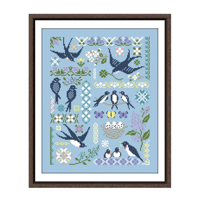 The Swallows in Spring sampler framed in dark wood: navy swallows, a nest with four eggs, butterflies and lilac borders on sky-blue fabric