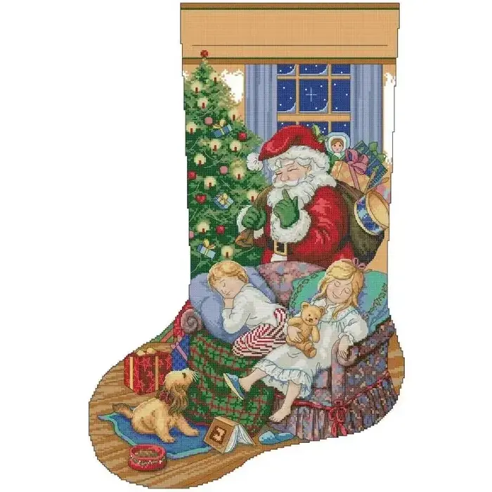 Christmas stocking cross stitch design CC-K13-21: Santa laying out gifts while two children sleep in an armchair with their puppies in a warm firelit room