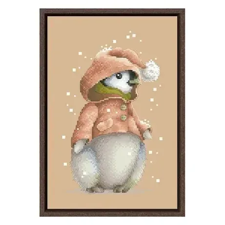 Penguin counted cross stitch design CC-K6-09: a baby penguin in a pink hooded coat with a white pompom, on flaxen fabric with snowflakes