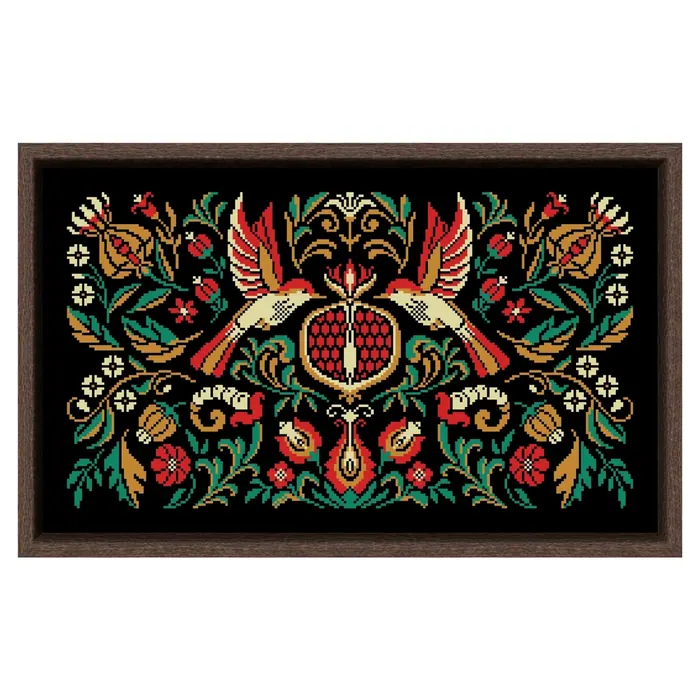 The Pomegranate Bird Night Songs design framed in dark wood: two red and gold birds with spread wings around a pomegranate on black fabric