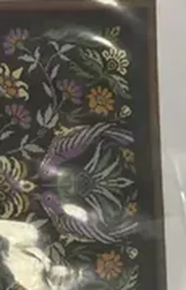 Buyer photo of the Amethyst Bird kit CC-K9-02: the violet birds and thistle design on black fabric seen through the packaging film